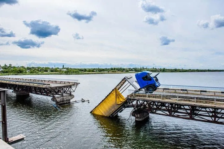 Truck falling into water from bridge failure.