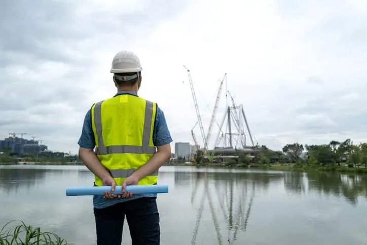 A young male engineer working at a cofferdam construction site