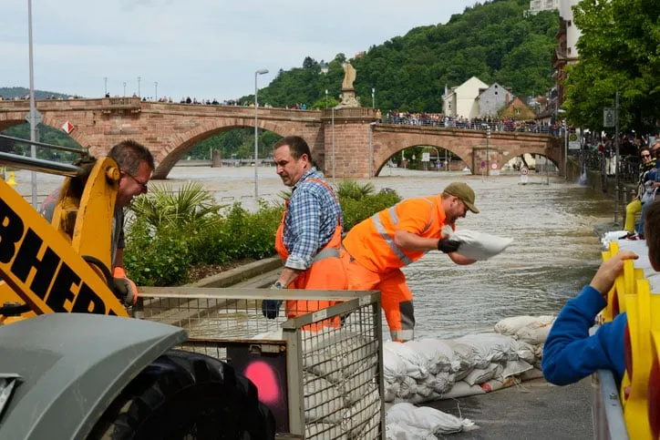 Men Throwing Sandbags at Construction