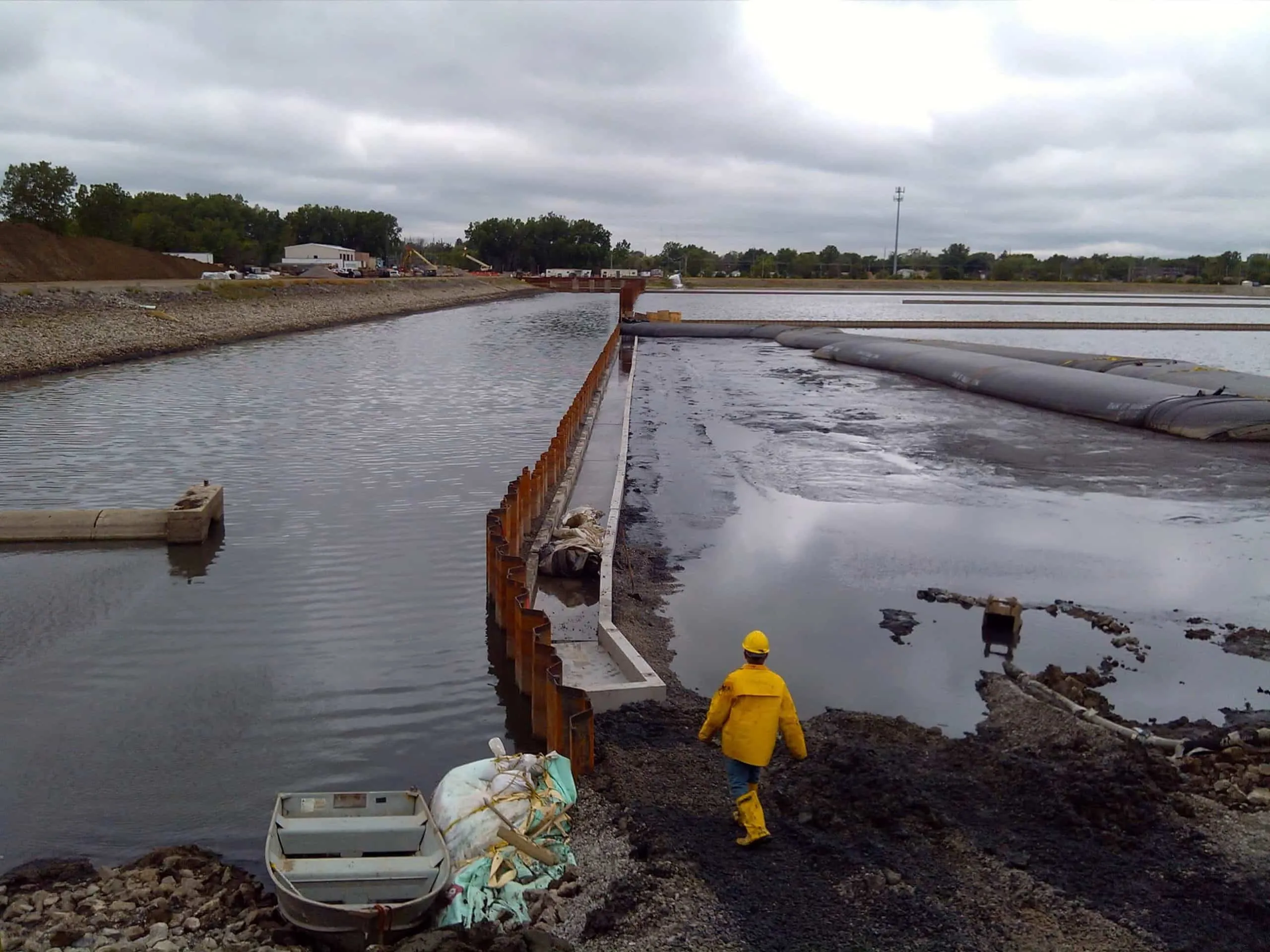 Water-filled cofferdam holding back water on an active project site