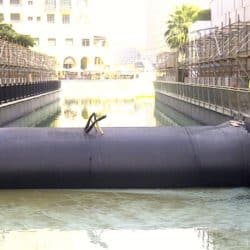 A water filled cofferdam damming water in a canal