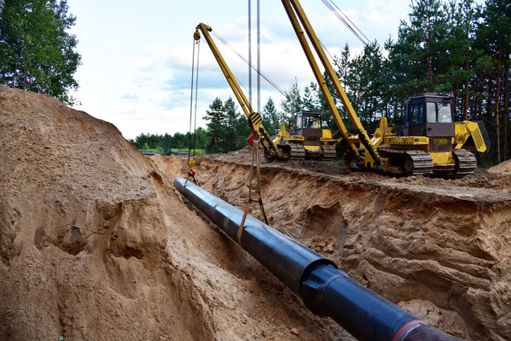 Natural Gas Pipeline Construction. Building of transit petrochemical pipe in forest area. Oil pipeline that would carry tar sands for oil refineries. Fossil fuels and crude. Pipes Welding
