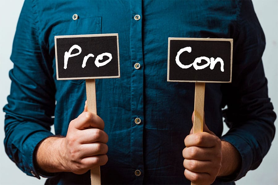 Contractor holding Pro and Con Signs