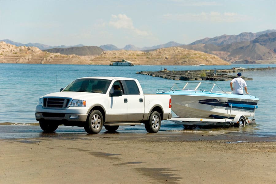 Truck with Boat Unloading into Lake